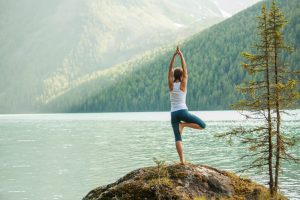 yoga pose next to lake